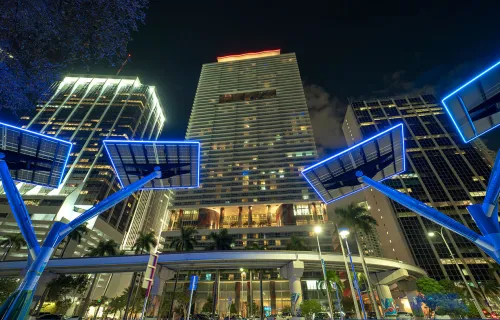 Blue solar photovoltaic panels mounted in modern city on street poles for electricity supply of streetlights and surveillance cameras