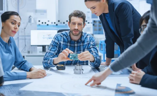 men and women working at a table