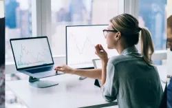 woman working on computer and laptop